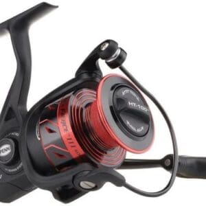 Close-up of a black and red fishing reel with a handle.