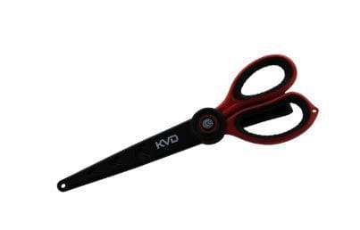 Black scissors with red handles lying on white background.