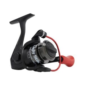 Black fishing reel with red handle and compact design.