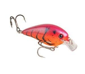 Bright pink and orange fishing lure with triple hooks.
